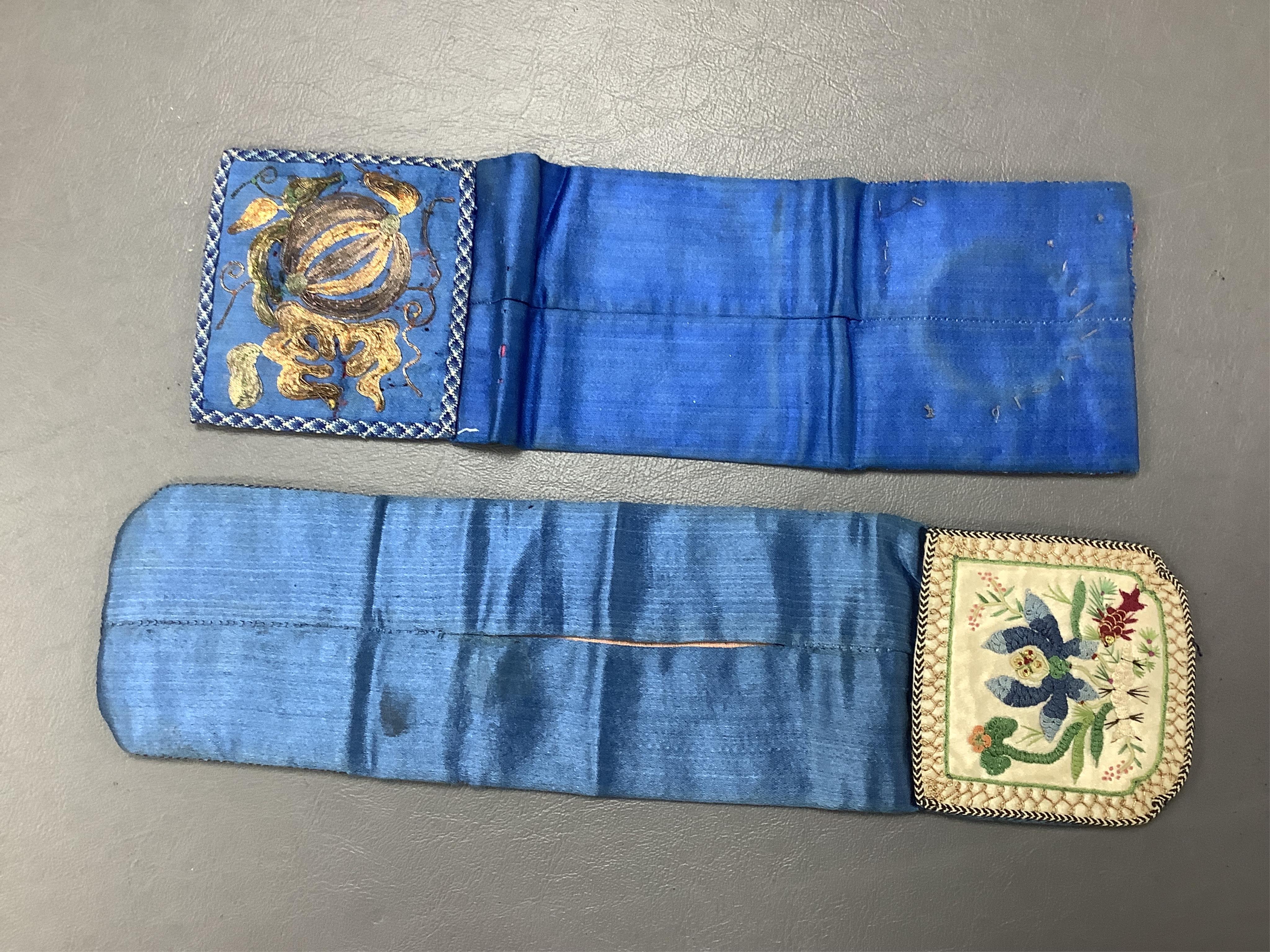 Two Chinese late Qing Dynesty coloured silk and gold thread embroidered belt purses, or ‘hebao’, for carrying coins, seals and fragrant herbs etc. One - 19cm long,in cream silk, with the embroidered words: “It’s music is